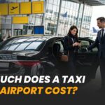 Driver helps a woman with her luggage as she steps out of a taxi at the airport terminal.